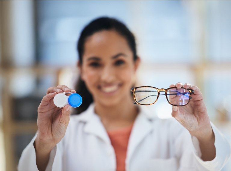 Eye Doctor Holding Contacts Case And Eye Glasses In Each Hand