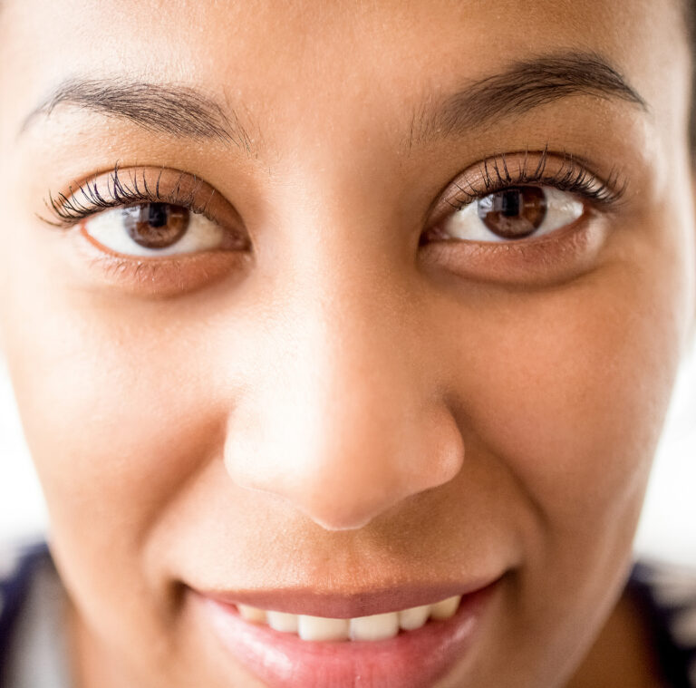 Looking into the camera confidently.